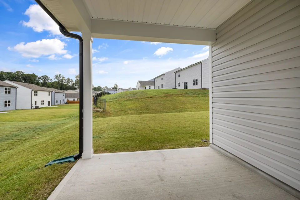 Concrete patio beside a green residential lawn